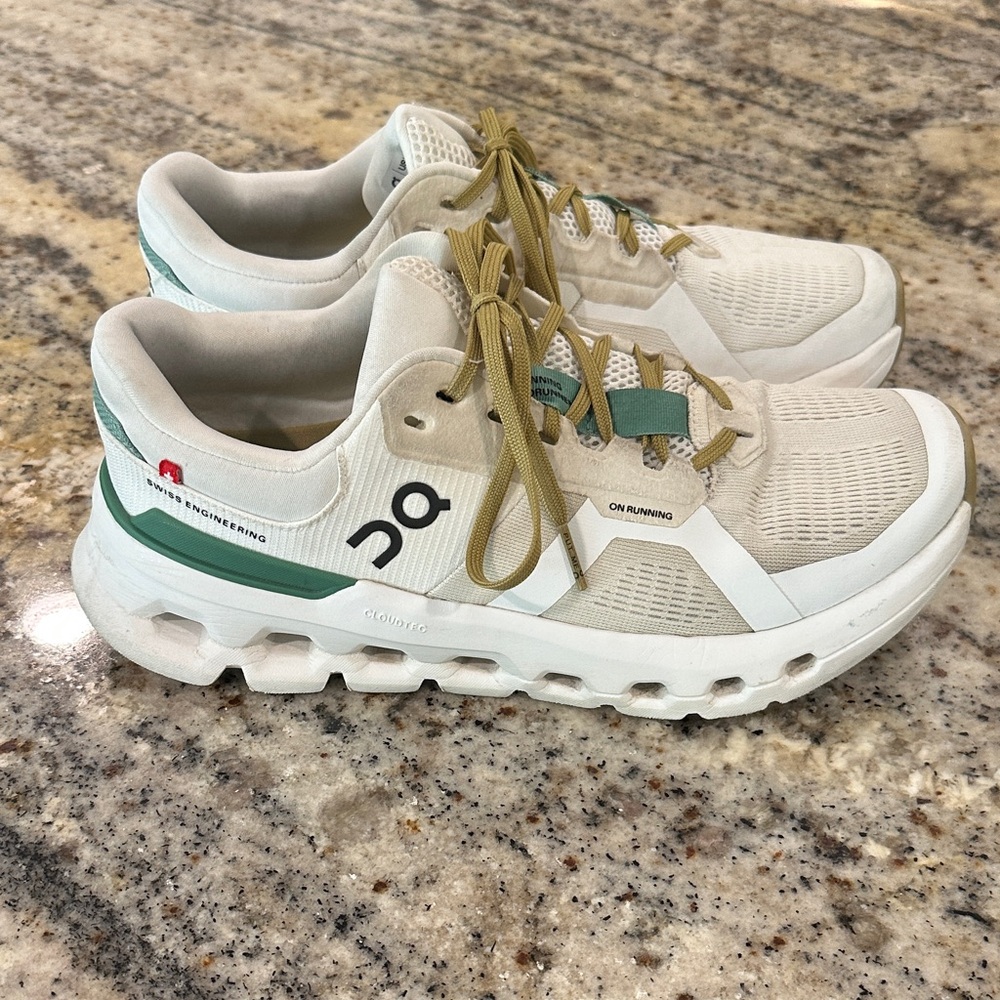 On Running Cream and Green Athletic Shoes